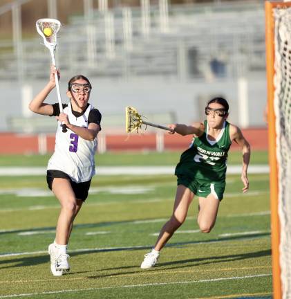 Riley Colligan (#3) races past a Dragon defender.