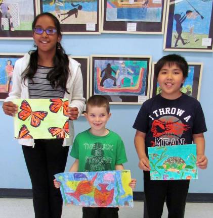 Sixth-grader Rishika Cherivirala, left, first-grader Wolf Castald and fourth-grader Reginald Juance.