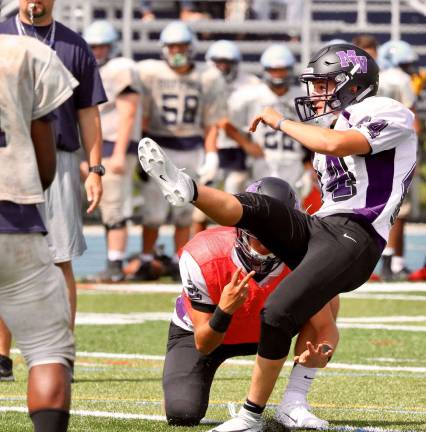 Photos by William Dimmit Crusader kicker Mike Boyle watches a field goal split the uprights during last Saturday's multi-team scrimmage at John Jay High School in Hopewell Junction.