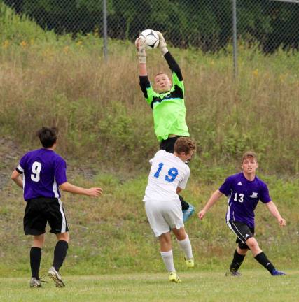 Photos by William DimmitCrusader Goalie Dylan McDermott makes a big save early in the game.