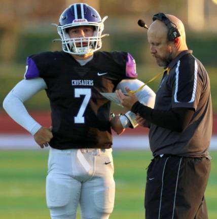 Crusader QB Michael Zrelak and Head Coach James Sciarra go over play selection late in the game.