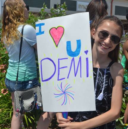Adrianna Lulgjuraj, 11 of Central Valley, poses with her homemade fan sign.