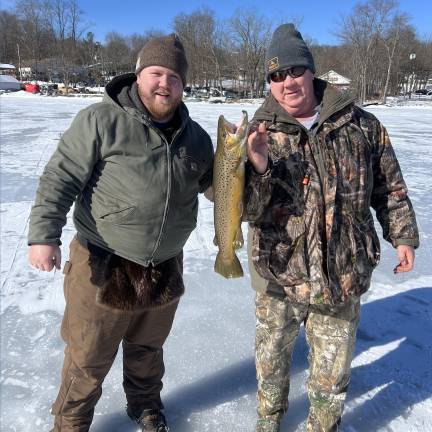 Top trout: Don Wittekind, right, holds up his prize fish alongside his son, Chris Wittekind.