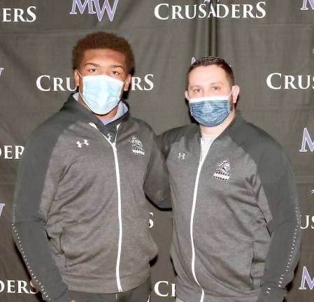 Senior Marcus Brown poses with Varsity Wrestling Head Coach John Gartiser.