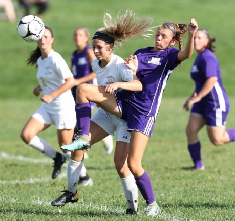 Gabrielle Mpasiakos (#8) battles with a Wizard defender for a loose ball.