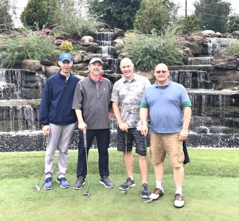 Tom Larsen (second from left) of Mediacom Communications served as chair of Catholic Charities Golf Outing committee.