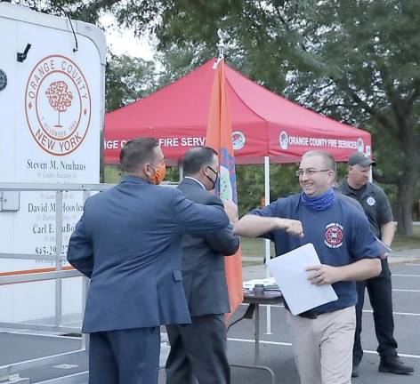 Orange County Executive Steven M. Neuhaus congratulates graduate William Duschaneck of the Maybrook Fire Department.