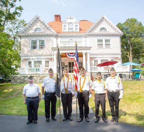 Members of the honor guard from American Legion 488 in Monroe stand in front of the historic Rest Haven.