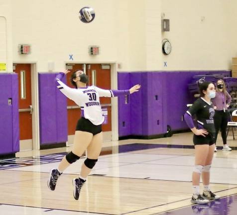 Jayla Farinacci (#30) serves the ball in the fourth set.