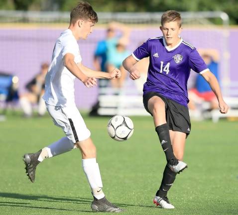 Crusader Jayden Jablonski (14) battles for control of the ball near midfield.