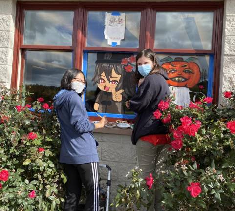 In past years, the NAHS students have painted storefronts in the downtown. However, due to unexpected road and sidewalk construction, the library offered all of their windows to the students.