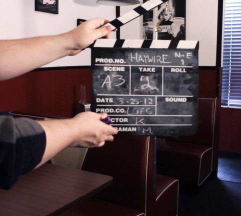 Provided photo Monroe native and Haywire grip Dee Wassel holds the slate for a shot on location.