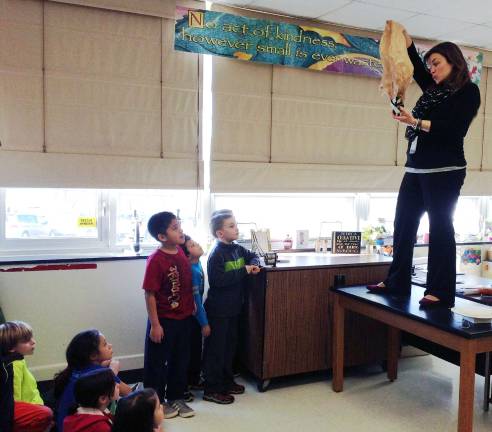 Drop it! North Main third-graders anticipate their egg drop package design being dropped by North Main &#xfe;&#xc4;&#xf2;STEaM&#xfe;&#xc4;&#xf4; teacher, Katie Oppelt. Will the raw egg survive?