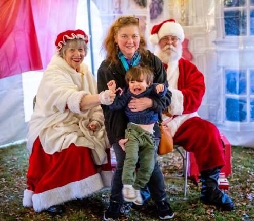 Little AJ Schmitt meeting Santa and Mrs. Claus for the first time at Monroe's Winterfest. He was not impressed.