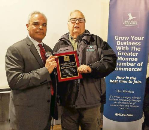 Edison Guzman, president of the board of the Greater Monroe Chamber of Commerce, presents Kevin Abrams of ADG Classic Realty with the Chamber Appreciation Award in recognition of the outstanding support his business has provided the chamber.