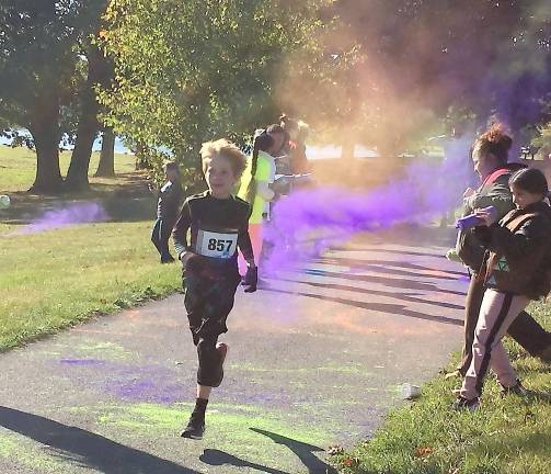 A young runner competes in the South Orange Family YMCA’s fifth annual 5K Color Run and Kids Dash last Saturday in Crank Park along the Mill Ponds.