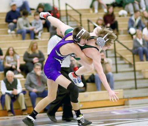 Crusader Grant Barczak sweeps his opponent into the air before recording a pin at 1:25 of their 120 lbs. contest.