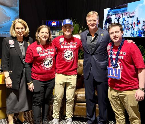 Left to right: Bonnie Carroll, president and founder of TAPS, Traci Voelke, Andrew Voelke and Ben Voelke.