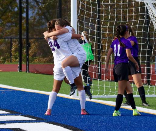 Crusader Liz Myers dives into the arms of Caroline Helbeck (#24) as she celebrates her go-head goal in the second half.