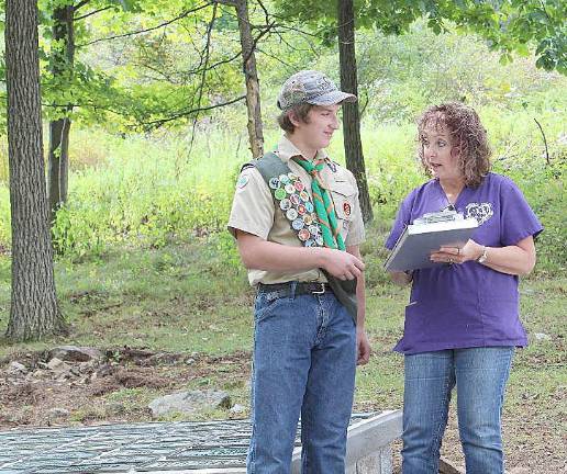 Scout Hunter Endrikat discusses his Eagle Scout project with Suzyn Barron of the Warwick Valley Humane Society at the “Resting Paws Pet Cemetery.