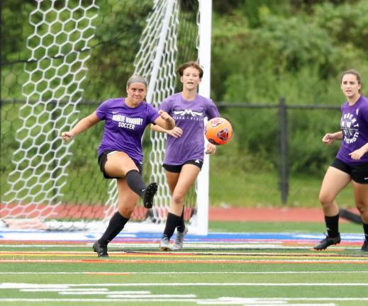 Kayla Bauer clears the ball away from the front of the Crusaders' net.