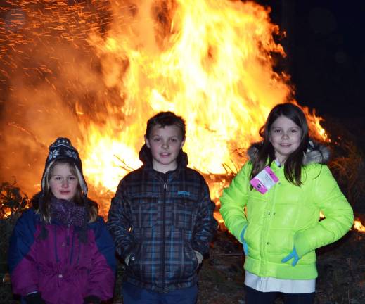 These young people pose in front of the bonfiire organized last Saturday evening by the Town of Tuxedo Recreation Department. From left to right, they are: Efthalia Maikisch, Jackson Brooks and Madison Tinger.