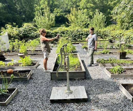 Warwick gardener Erin Andersen talks about gardening in Warwick, N.Y., with a guest, Holly Odgers, of Hamburg, N.J. Photo by Bill Woolley.