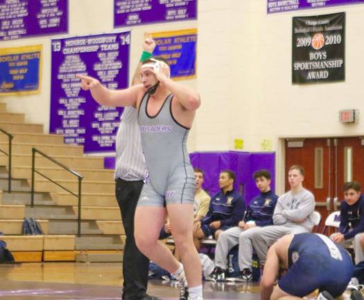 Match of the night: David Strauss (220 lbs.) points toward his teammates after wining his match in overtime.