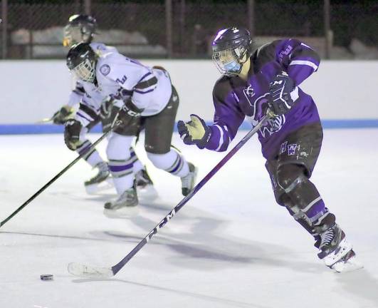 Senior Andre Estrella races past two White team defenders during last Friday’s scrimmage under the lights at the old Bear Mountain Ice Rink. Photos by William Dimmit.