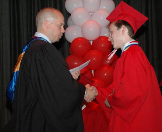 Photos by Ed BaileyPrincipal Jason Schrammel congratulates Arik Mazejko.