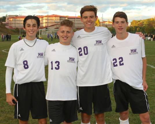 In a ceremony before the game the Crusader seniors and their parents were given flowers and posters. Pictured from left to right are: Max Schwartz (#8), Tyler Lucas (#13), Kevin Grimes (#20) and Sean Coddington (#22).