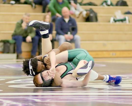 Crusader, Jordan Brown pins his Dragon opponent at 2:15 of their 99 lbs. bout.