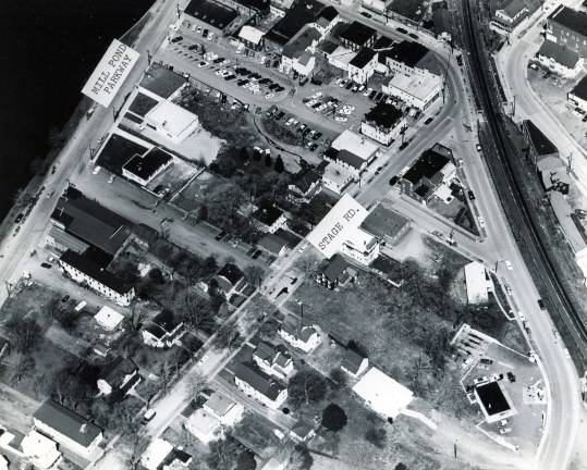 Photo courtesy of the Monroe Historical Society. This aerial photo of downtown Monroe sometime circa 1960s. Among the properties that can be identified are Village Hall on Stage Road, Monroe Free Library and the old movie theater on Mill Pond Parkway. Notice the train tracks. Notice the traffic flow and parking.