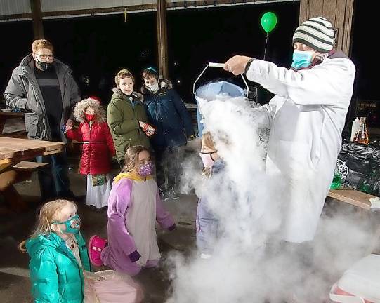 Celebrants enjoy an ice and fire Mad Science Show at Chabad’s Purim in the Arctic.