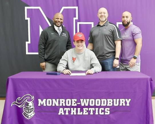 Conor Fitzgibbon seated signs his letter of intent to attend Marist College with Monroe-Woodbury Athletic Director Howard Harrison, Head Coach James Sciarra and Assistant Coach Jesse Gotay. Photo by William Dimmit.