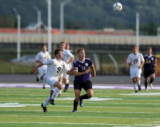 Peto Klish (#14) races with a Dragon defender for a loose ball