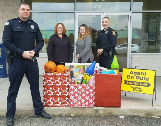Provided photo Heather Laurencell, processing manager for Weichert&#x2019;s Monroe office (second from left), and Weichert sales associate Stephanie Dolan-DeLeon are joined by officers Timothy Young (left) and Anthony Grosso from the Monroe Police Department with the toys they collected for local children and families in need this past holiday season.
