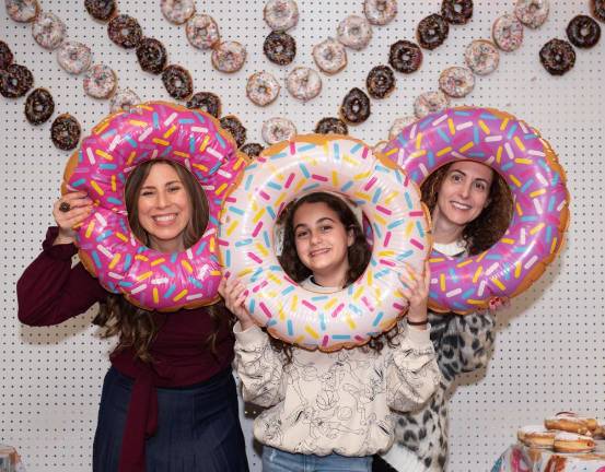 Chana Burston celebrates Chanukah with Liat Mosker and daughter Yasmine of Monroe, at the Community Chanukah Bowl at Colonial Lanes of Chester with Chabad of Orange County.