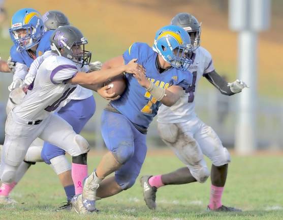 Justin Gumbs (#16 on left) strips the ball away from the Wizard ball carrier to give the Crusaders one last shot.