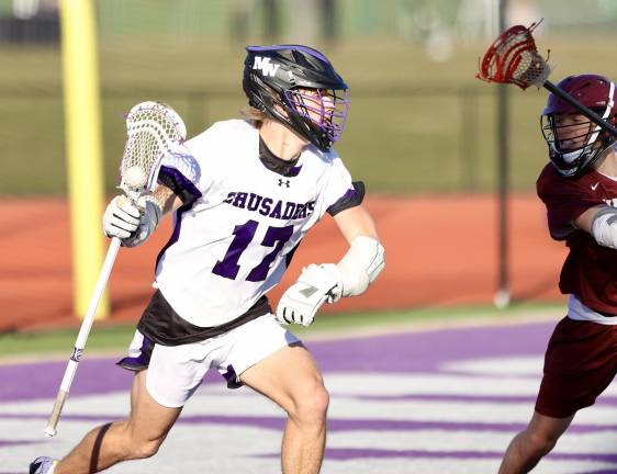 Liam Williamson (#17) brings the ball out from behind the net.
