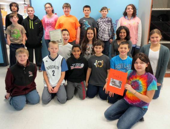 Sixth grade students at George Grant Mason School in Tuxedo have adopted a wolf following a recent visit to the Lakota Wolf Preserve in Columbia, N.J., a 12-year-old alpha named Teeko. Pictured here are the sixth graders. In front, Talia Posta holds a picture of Teeko; in the front row, from left to right: Thomas Iazzetti, Ryan Tinger, Ethan Cardona, Andreas Lymberis, Jake Spivak and Emma Mulvaney; second row: Joseph Nouri, who is holding the certificate of adoption), Gabriella Hekl and Rosalie Rodriguez; and in back: Shane Kearney, Ali Imran, Daniel Witt, Natalyn Peralta, Brayden Higgins, Joseph Arcuni, John Castricone and Adrianna LaBar.