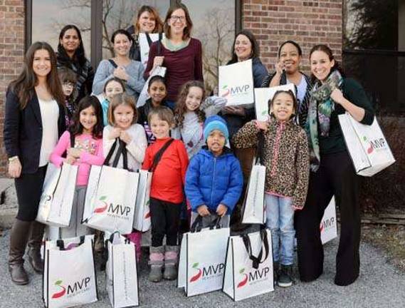 Provided photos Showing off their care packages to the St. Luke's Birth Center in Newburgh are: in the back and from the left: Shantelle Lord, Priya Raja, Heather Milano, Jennifer Koby, Annie Labrada, Dorey Houle, Latrice Campbell, Yasmine Kalkstein, Annette Koby, Olivia Houle, Sanjita Raja and Sivan Kalkstein. Front row: Jael-Lucia Milano, left, Sara Labrada, Matan Kalkstein, Matthew Campbell and Victoria Campbell.