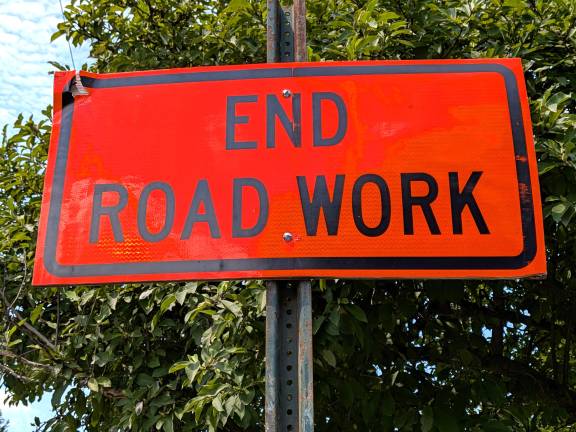 Municipal sign designating where road work has ended in the area.
