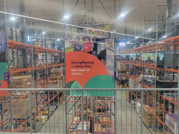The group gathered at the Regional Food Bank’s new Montgomery facility, which was set to double the organization’s local food storage capacity. Their shelves are now half empty, according to Rep. Pat Ryan’s office. Photo by Dylan Skriloff.