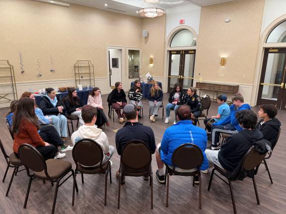 The Chabad CTeen group listens intently.
