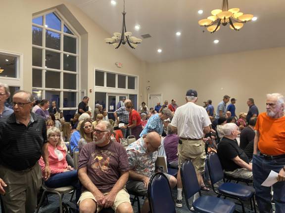 Crowd gathers at Monroe Town Hall for a question-and-answer session with the owner of highly-discussed parcel of land on Round Lake.