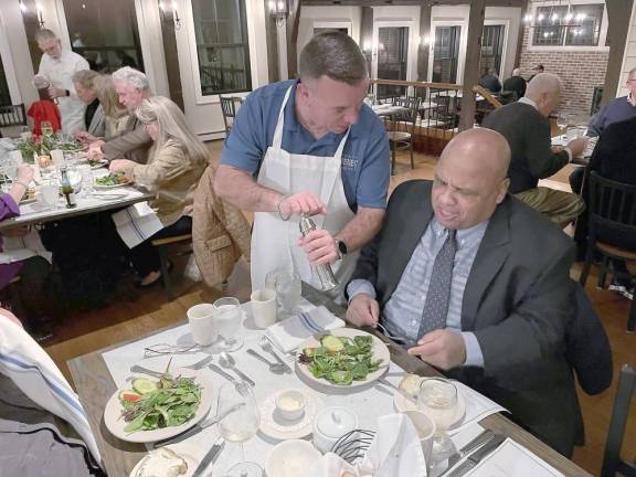 Photo credit: Peter Lyons Hall#1590: Assemblyman Karl Brabenec offers fresh ground pepper to dinner guest.
