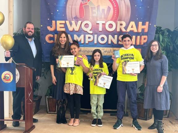 Rabbi Pesach and Chana Burston, and JewQ instructor Rosie Rimler (far right) congratulate JewQ regional Champions Arianna Briggins, of Monroe, Heather Sentell, of Monroe and Shepard Hoffman.