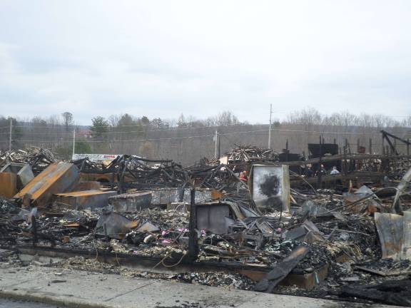 The remains of the Mid-State Lumber warehouse on Friday afternoon. Photo by Nathan Mayberg
