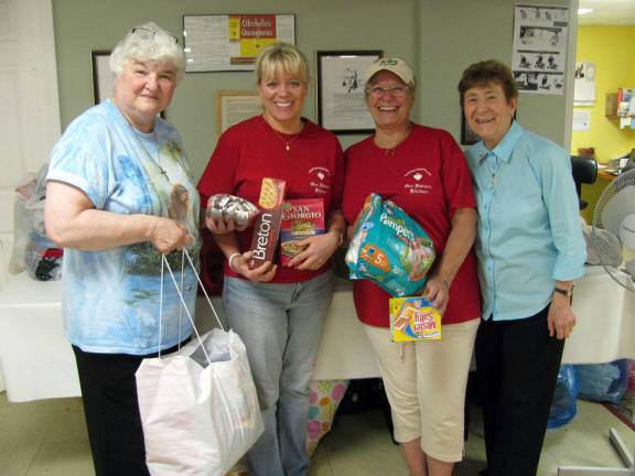 At Sacred Heart Church's My Father&#xed;s Kitchen: From left to right: Michele Ruggiero, Jonelle Rizzi, Susana Rodriguez and Sr. Carmel Therese Favazzo - delivering food and clothing donated by members of the Union of Catholic Apostolate and the Bible Sharing group.